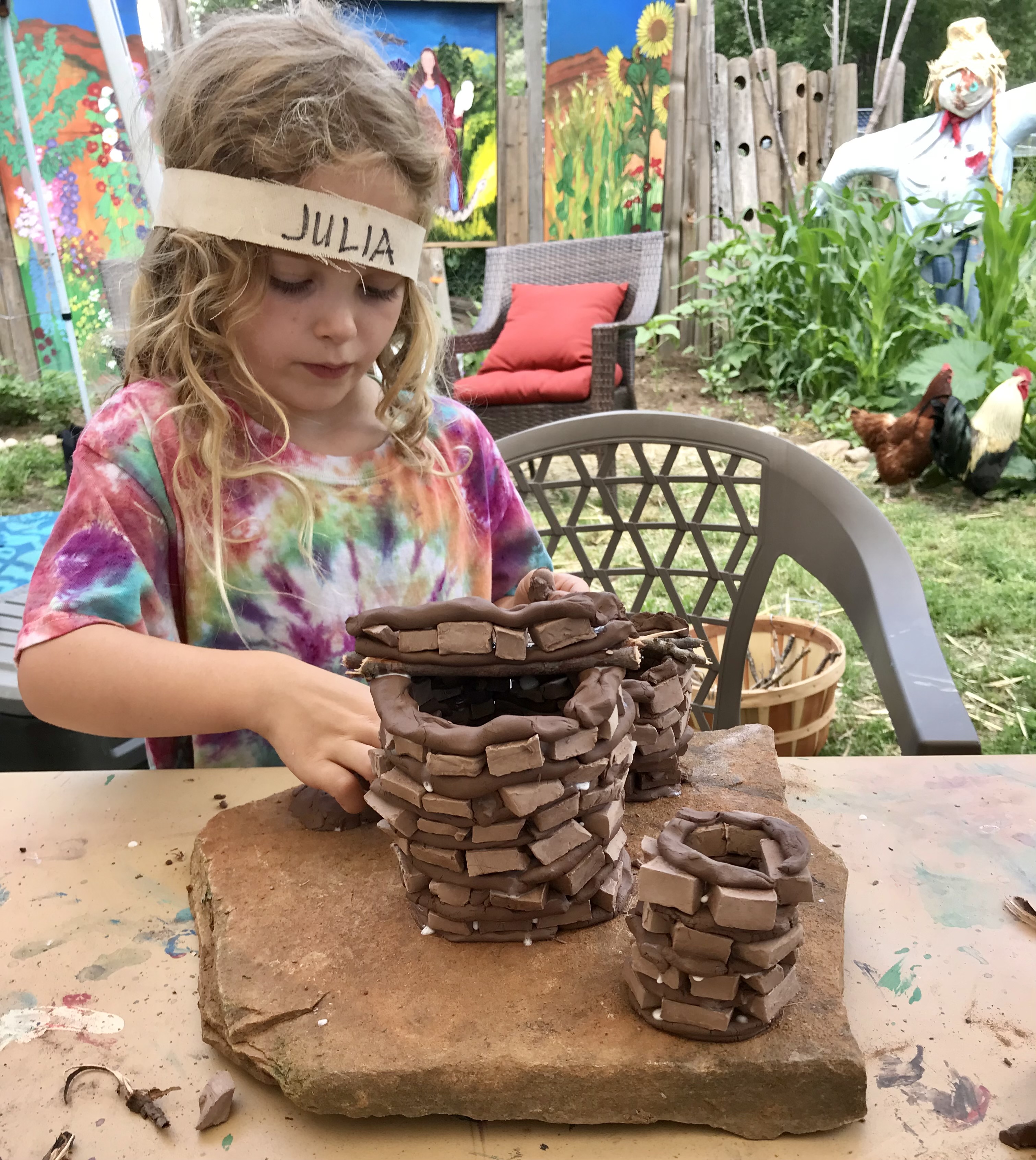 Julia crafting clay coil pots